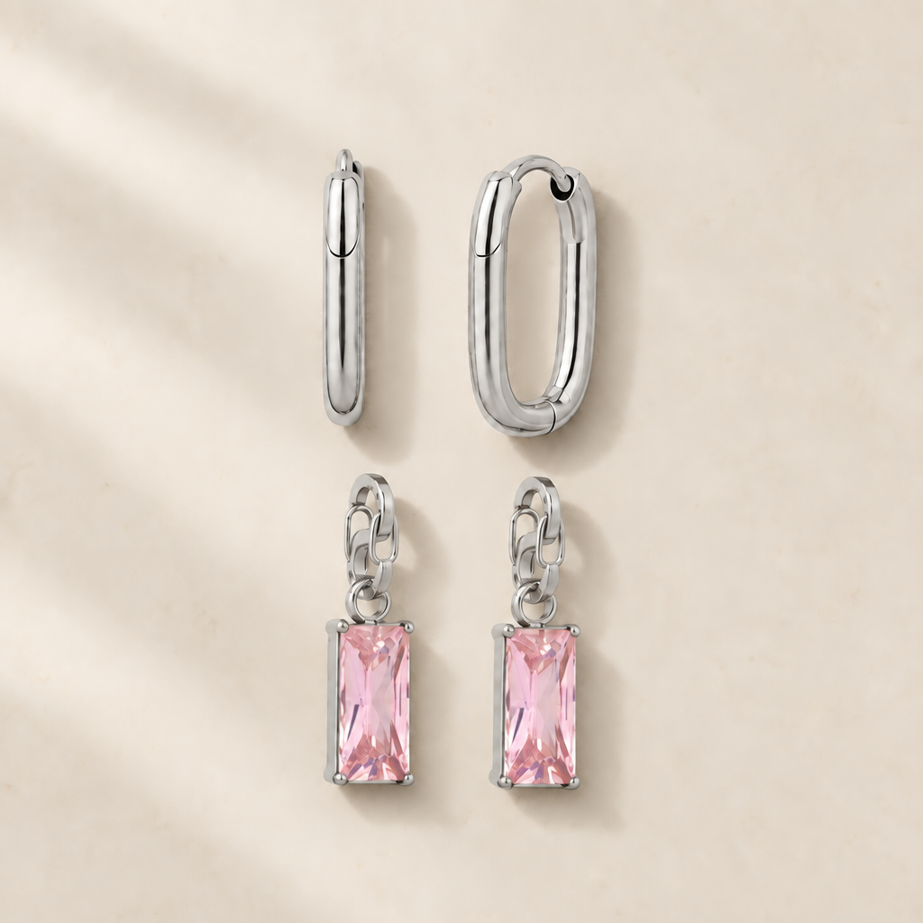 Steel Frame earrings and two pink charms on a light background